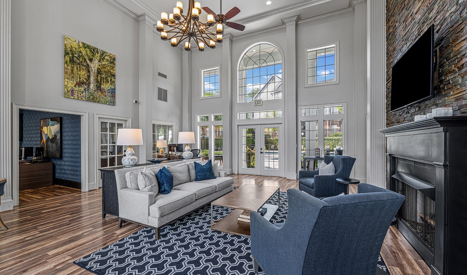 Lobby Spacious lobby with wood floors and large windows with a fire place